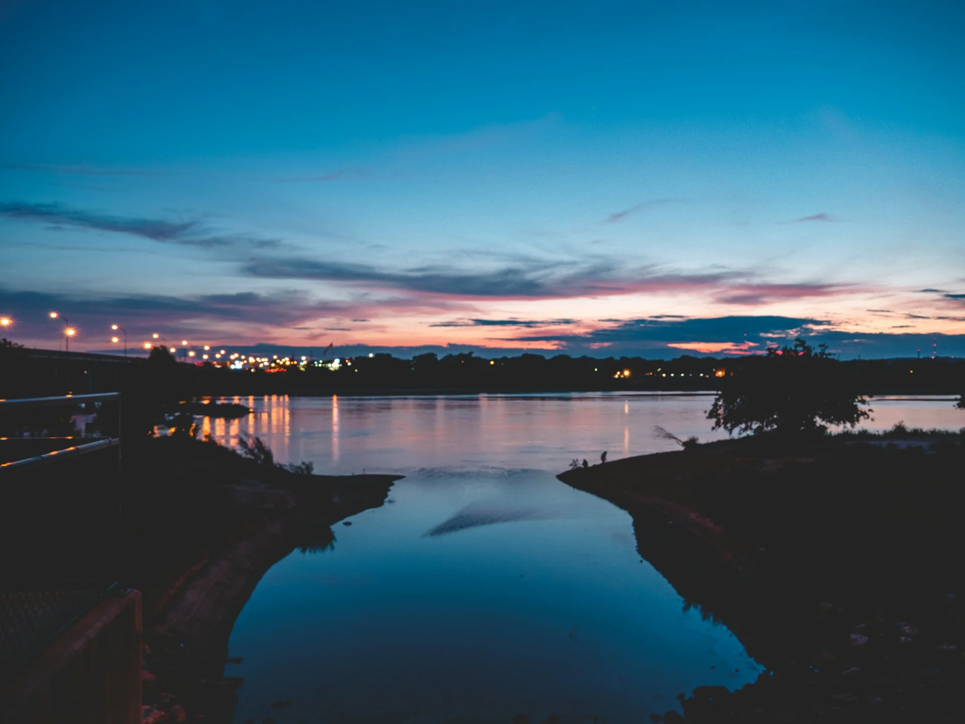 Oklahoma landscape at sunset with open sky and water, representing long-term infrastructure planning